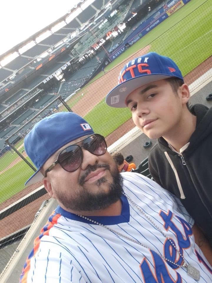 A young guest holding a baseball from the stands